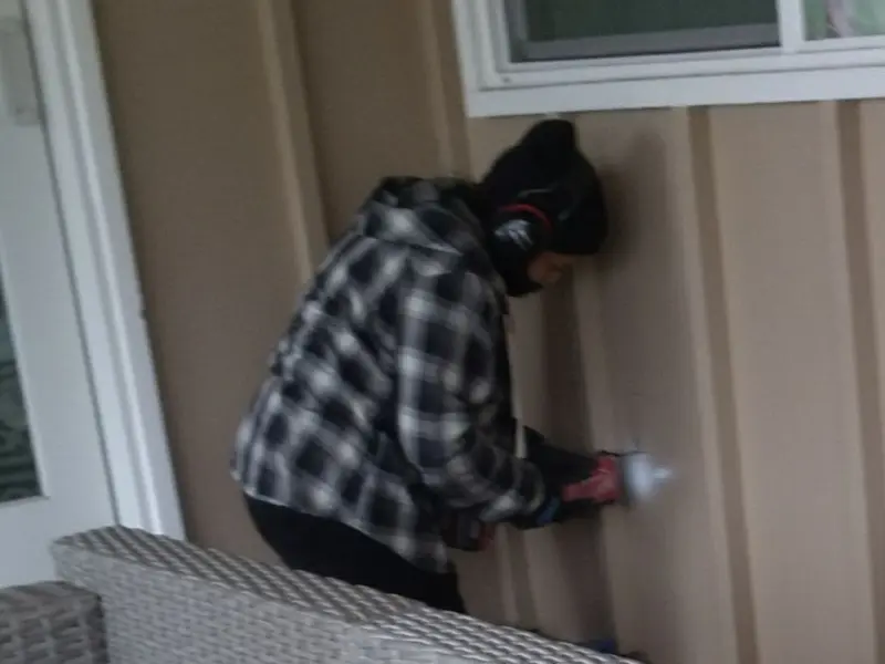 Professional electrician installing an exterior outlet in Red Bud